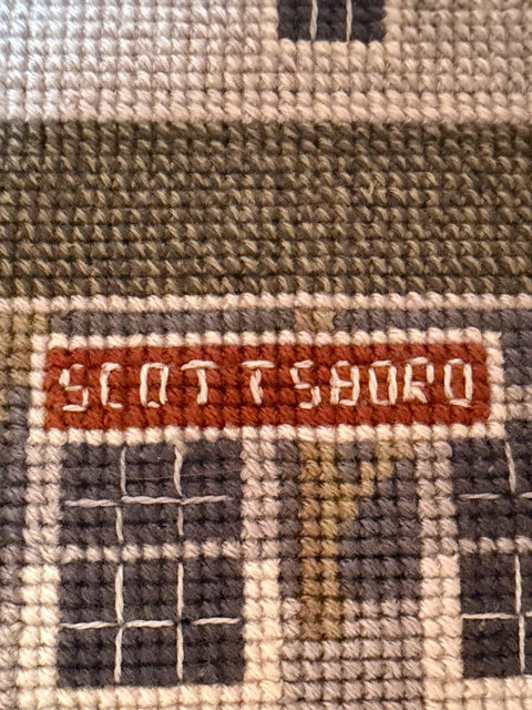Framed Cross-Stitch Artwork Featuring a Charming Train Station Scene