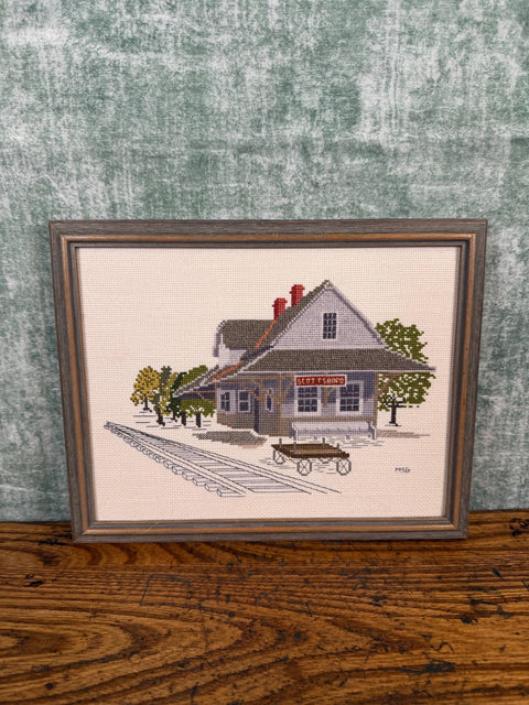 Framed Cross-Stitch Artwork Featuring a Charming Train Station Scene