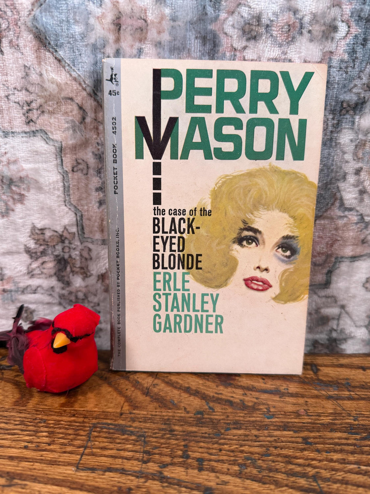 May include: A vintage paperback book titled "Perry Mason" by Erle Stanley Gardner. The cover features a blonde woman with a black eye. The book is a Pocket Book edition, priced at 45 cents.