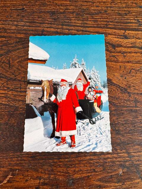 Vintage Christmas Postcard Featuring Santa and Sleigh in Snowy Scene