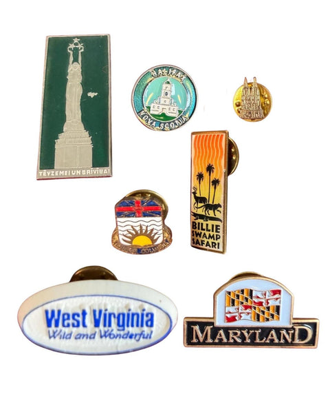 Collection of Vintage Travel Souvenir Pins from Various Locations