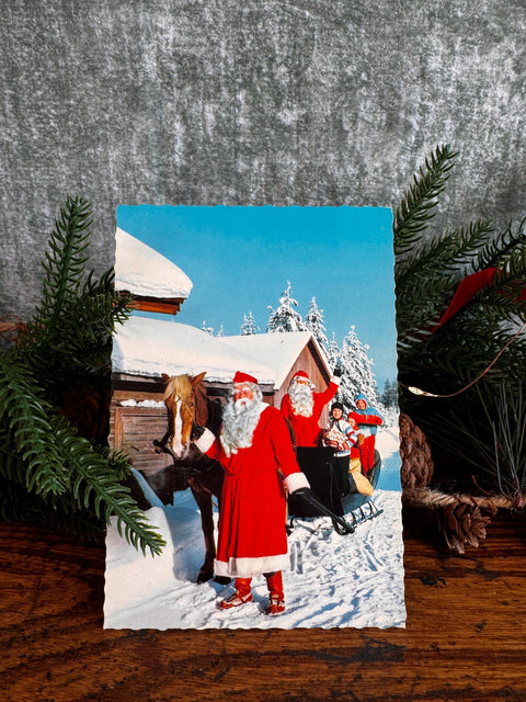 Vintage Christmas Postcard Featuring Santa and Sleigh in Snowy Scene